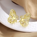 Elegant gold butterfly stud earrings with sparkling cubic zirconia on silk background - Gold