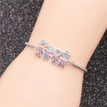 Silver stainless steel chain bracelet with crystal boy and girl charms on female wrist - Family of Four (Parents & Children)