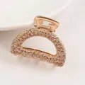 Detail view of golden half-moon hair claw clip with floral rose relief pattern - Semicircle - Gold