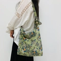Floral corduroy shoulder bag with green pattern and side bow detail on white outfit - Corduroy Green Floral