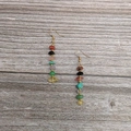 Detail of colorful stacked stone teardrop earrings with gold bead accents on wood - Gold-Rainbow