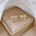 Detail of luxury gold butterfly earrings with zircon inlay on a silk background - 925 Silver Pin + Copper Plating / Bowknot Stud Earrings (D522)