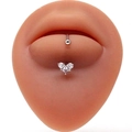Close-up of heart-shaped stainless steel lip stud with sparkling clear zircon inlay - Triple Hearts Zirconia / Silver