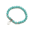 Detailed macro of turquoise beaded bracelet featuring heart lock charm and vintage spacers - Lock