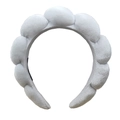 Close-up of thick light gray sponge headband with soft terry cloth texture for spa use - White Golden Velvet