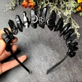 Detail showing handmade black raw stone headband with metal star and moon charms - Black Crystal + Triple Moon