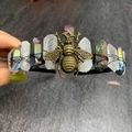 Macro shot of detailed vintage bronze bee ornament and rainbow crystal headpiece - White Crystal + Aura Quartz + Antique Bronze Wire + Bee
