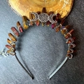 Detail of handcrafted moon crystal crown with iridescent stones and wire wrapping - Deep Purple + Silver Moon