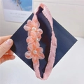 Close-up of pink mesh flowers with pearls on an elastic headband for girls - Hair Band / Korean Pink Flower