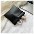 Minimalist black leather mini storage pouch containing a USB cable and lipstick - Large / Black