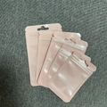 Close-up of four pink resealable plastic pouches with zipper closure and hanging hole - Pink (6x10cm)