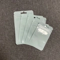 Detailed view of white plastic self-sealing bags with hanging holes on grey fabric - Blue (8x13cm)