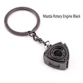 Matte black metal keychain shaped like a Wankel rotary engine with a sturdy steel ring - Black Rotary Engine