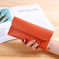 Slim long envelope wallet in vibrant orange pebbled leather with buckle strap - Orange