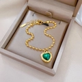 Titanium steel gold beaded bracelet featuring a vintage green heart pendant in a jewelry box - Heart Green Gemstone Bead Style / Gold