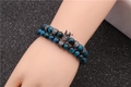 Set bracciale con occhio di tigre blu e ciondoli a corona micro-pavé su sfondo nero - Set da 2 pezzi