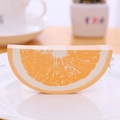 Creative 3D orange slice shaped memo pad with realistic fruit texture on a white plate - Orange