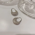 Macro shot of silver crescent hoop earrings featuring full pavé-set sparkling zircon stones - Silver