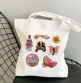 White canvas tote bag featuring colorful sunflower, butterfly, and TPWK rainbow prints - TPWK Multi-color Mixed Fan Merch Style (STD27-Y)