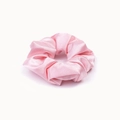 Close-up of pink silk satin scrunchie showing glossy fabric texture and pleat details - Pink