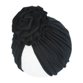 Detailed view of black knitted cotton baby turban with a large layered floral ornament - Black
