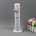 Gray velvet cylinder display stand with round base showing elastic hair ties and scrunchies - Ice Grey Velvet Column