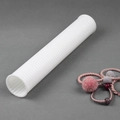 Macro shot of white corrugated display stand tube for hair ties and jewelry storage - Plastic / White Plastic Tube
