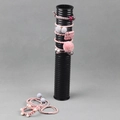 Pink and grey velvet hair ties displayed on a sleek vertical black stand organizer - Plastic / Black Plastic Tube