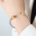 Twisted stainless steel cable open bangle with gold accents and a red zircon stone - Z059-Red Zirconia Single Layer
