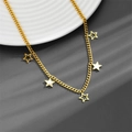 Detailed view of a gold star necklace with white shell inlay on a textured background - Star Necklace A601