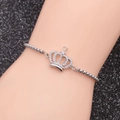 Silver crown pendant bracelet with box chain and zircon inlay worn on a model's wrist - Crown 3-Box Chain Heart Hollow Crown