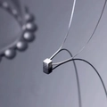 Minimalist S925 sterling silver cube necklace on reflective dark background - One Cube Necklace / 925 Silver