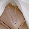 Macro detail of a heart-shaped zircon pendant on a silver titanium steel chain - Silver