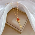 Luxurious gold crown key necklace with red pear-cut gemstone and crystal accents - Red Water Drop Crown Key Style (F105)