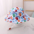 Kids sun bucket hat with colorful cartoon dinosaur surf print and windproof chin strap - EU 48 / Surfing Dinosaur