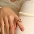 Close-up of heart-shaped pink zircon ring in 18k gold plating on a finger - Gold Pink Zirconia