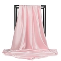 Detailed close-up of smooth pink satin square scarf hanging on a metal display rack - Pink