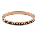 Detail view of rose gold stainless steel bangle with black enamel and gold dot patterns - Black Rose