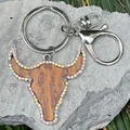 Macro detail of cow head leather keychain with rainbow rhinestones and leopard print texture - Brown Leopard
