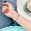 Minimalist silver chain bracelet featuring a geometric circular ring link on wrist - Circle Chain Link Bracelet