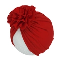 Macro shot of red pleated cotton baby turban hat featuring a large layered floral detail - Red