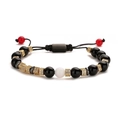 Macro detail of braided beaded bracelet with black stones and gold cubic zirconia spacers - Black Agate