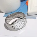 Macro detail of silver rectangular quartz watch with flexible stretch expansion band - Men's White Dial / Silver