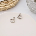 Silver screw-on earring converter for non-pierced ears on a white ceramic tray - Suitable for Studs / Silver