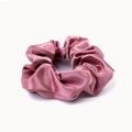 Close-up of pink satin scrunchie with silky luster texture and soft elastic band - Deep Pink