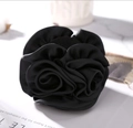 Elegant black fabric rose hair clip featuring layered 3D petal design in satin finish - Black