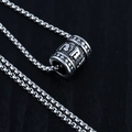 Silver cylinder pendant necklace with embossed daisy and bear details on box chain - Cylinder Mantra + Steel Chain