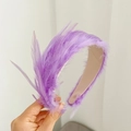Detail view of purple feathers on a pink headband showing texture and fine handcraft - Light Purple Feather Headband