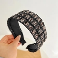 Detail of black wide-brimmed knotted headband with woven texture and metallic beads - Black Wide Edge Headband