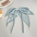 Close-up of light blue satin bow hair clip featuring elegant long ribbons and pearl charms - Ribbon Pearl Bow Hair Clip / Blue